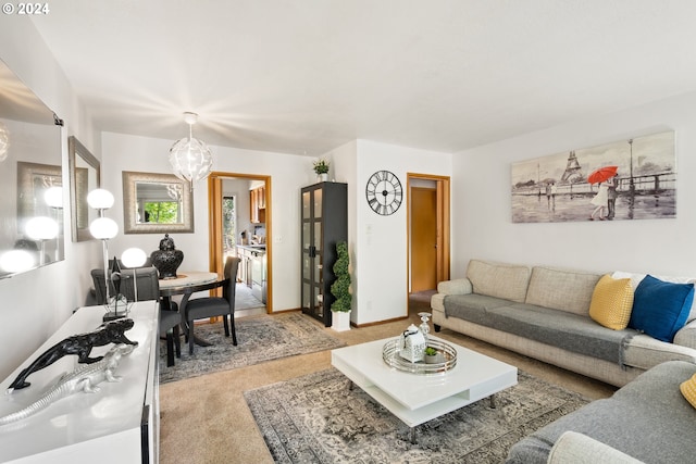 living room with a chandelier and carpet