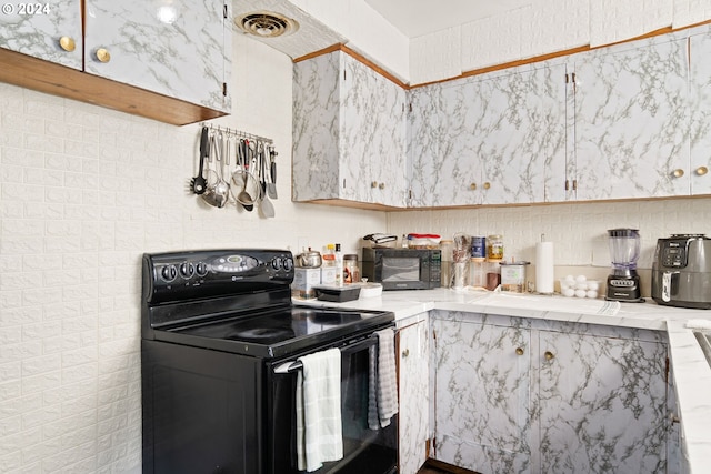 kitchen with black appliances and tile countertops