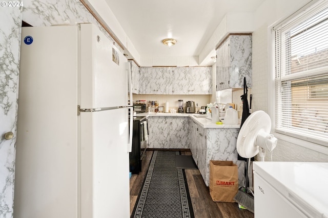 kitchen with white cabinetry, white refrigerator, dark hardwood / wood-style floors, and plenty of natural light