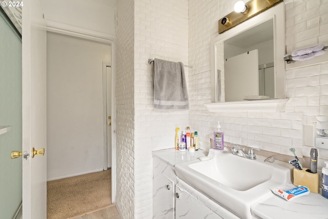 bathroom featuring decorative backsplash, vanity, and hardwood / wood-style flooring