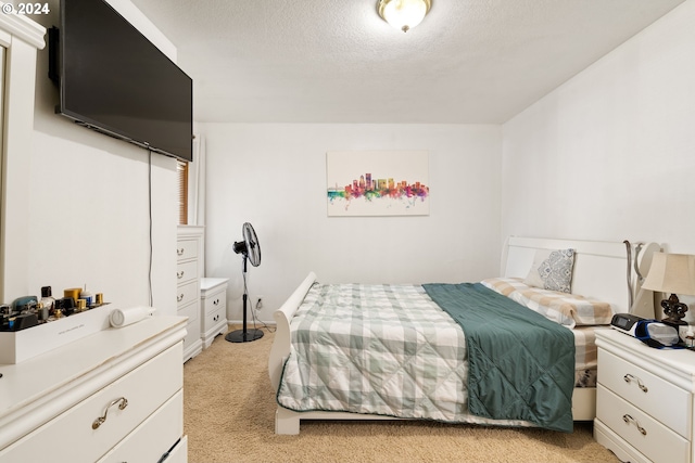 carpeted bedroom featuring a textured ceiling