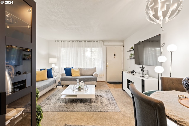 living room with light carpet, a textured ceiling, and an inviting chandelier