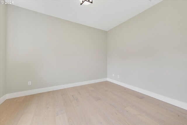 spare room with light wood-type flooring