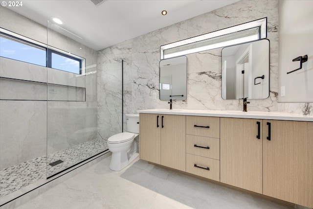 bathroom featuring tile walls, backsplash, a tile shower, vanity, and toilet