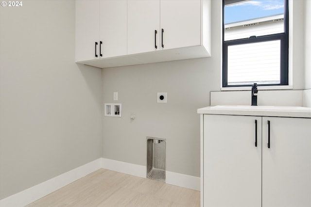 laundry room featuring cabinets, a healthy amount of sunlight, sink, and electric dryer hookup