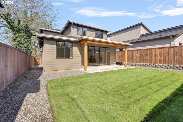 back of property with a patio and a lawn