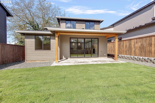 back of property featuring a yard and a patio