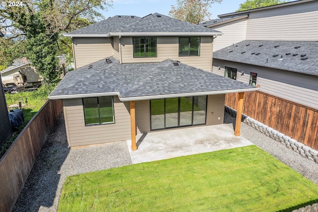 rear view of house featuring a patio and a yard