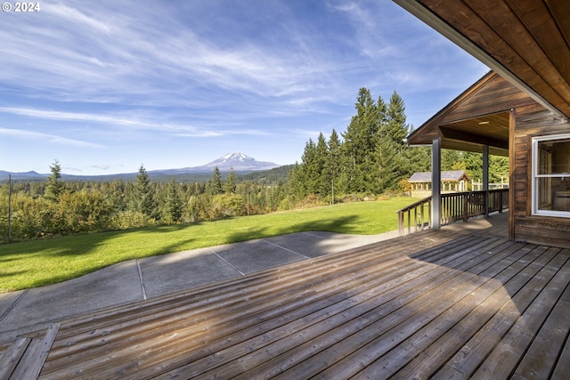 deck featuring a mountain view and a yard