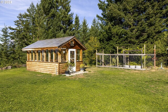 exterior space featuring a yard and an outdoor structure