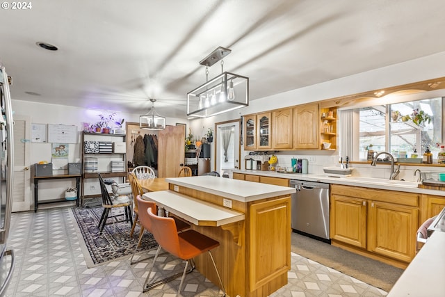 kitchen with dishwasher, a center island, decorative light fixtures, sink, and a notable chandelier