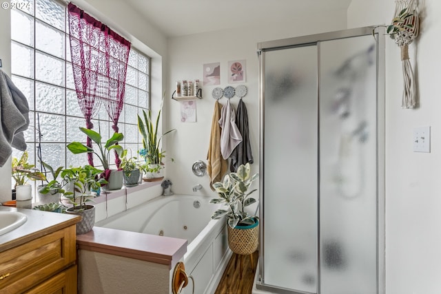 bathroom featuring shower with separate bathtub, vanity, and hardwood / wood-style floors