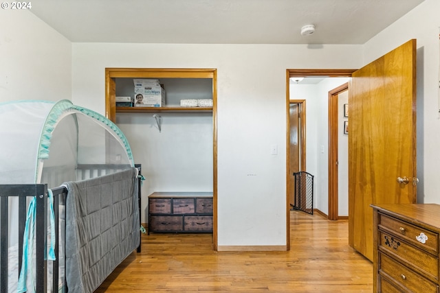 bedroom featuring light wood-type flooring and a closet