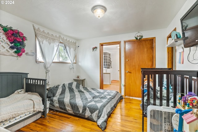 bedroom with light hardwood / wood-style flooring