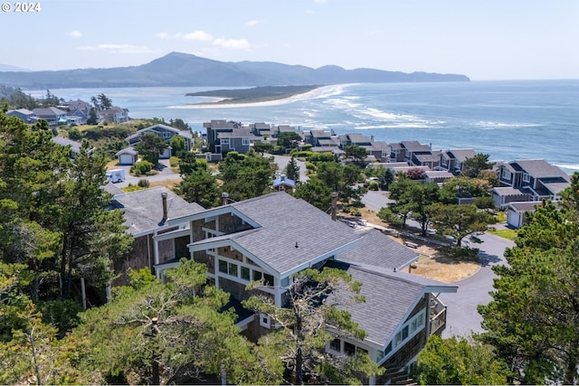 drone / aerial view featuring a water and mountain view