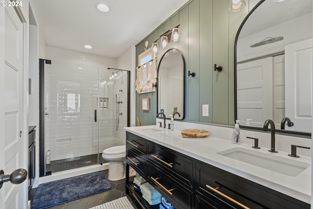 bathroom with vanity, toilet, tile patterned floors, and a shower with shower door