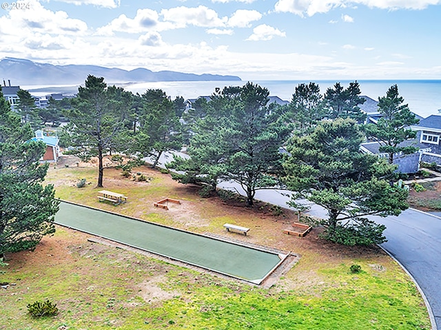 birds eye view of property with a water and mountain view