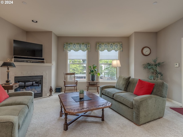 living room featuring carpet flooring and a tiled fireplace