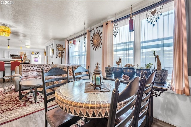 dining space featuring a textured ceiling and dark hardwood / wood-style floors