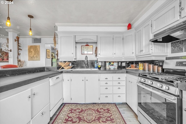 kitchen featuring pendant lighting, dishwasher, sink, crown molding, and gas stove