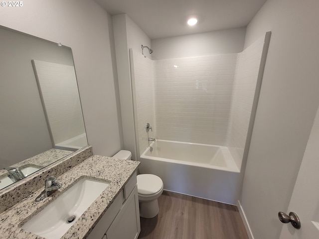 bathroom featuring vanity, tub / shower combination, wood finished floors, and toilet