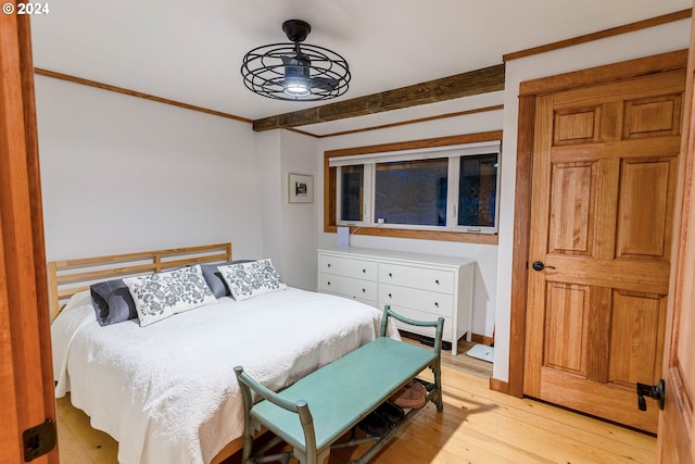 bedroom featuring light hardwood / wood-style floors and crown molding