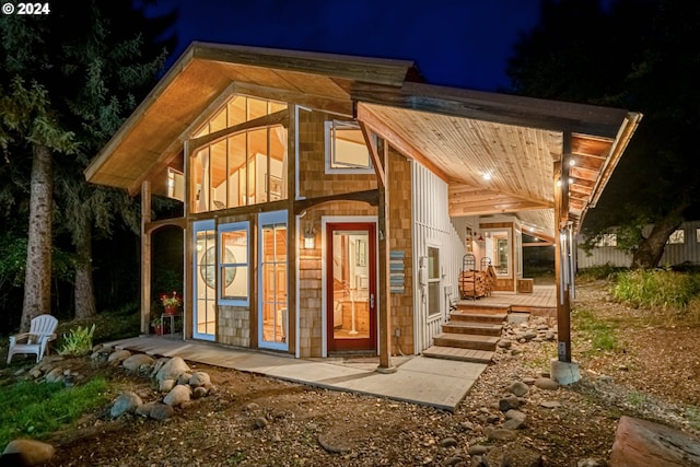 view of back house at twilight