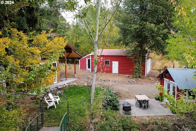 view of yard with a patio and an outbuilding