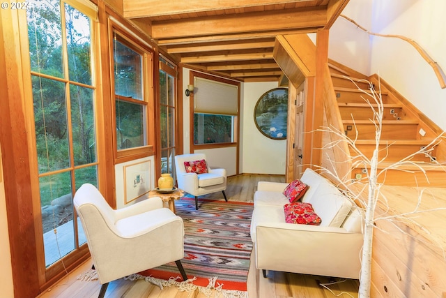 living area featuring hardwood / wood-style floors and beam ceiling