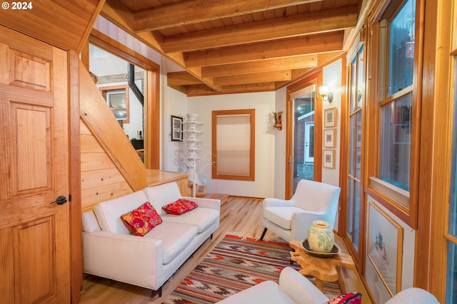 sitting room with beam ceiling, light hardwood / wood-style flooring, and wood ceiling