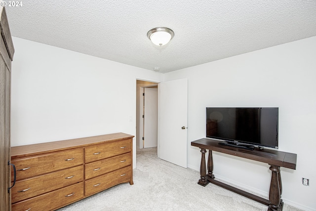 carpeted bedroom with a textured ceiling