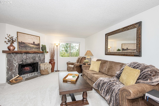 carpeted living room featuring a stone fireplace and a textured ceiling