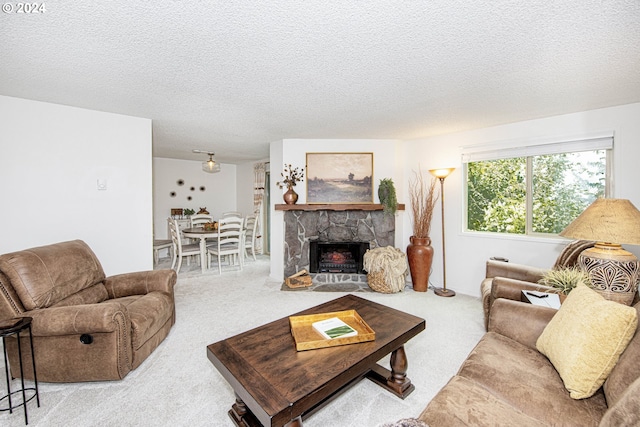 living room featuring a fireplace, light colored carpet, and a textured ceiling