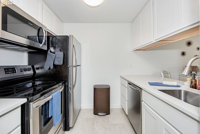 kitchen featuring stainless steel appliances, sink, and white cabinetry