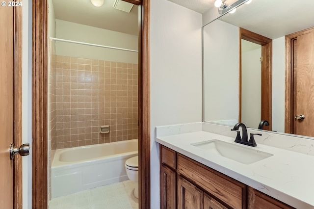 full bathroom with vanity, toilet, and tiled shower / bath combo