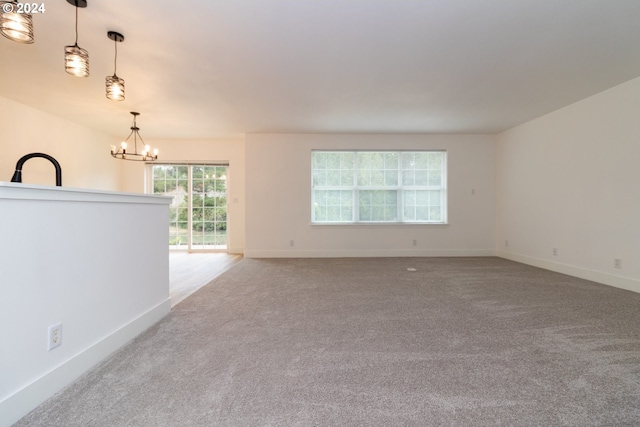 9 Waterford Downs, Florence, OR 97439 - carpeted spare room featuring a chandelier and baseboards