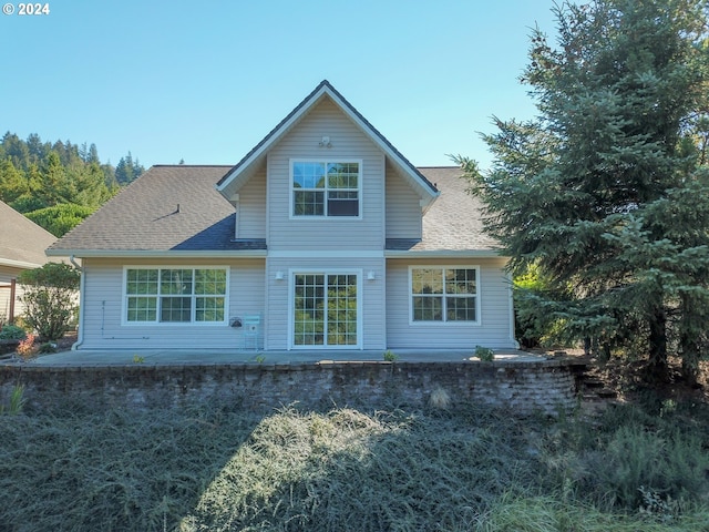 9 Waterford Downs, Florence, OR 97439 - back of house featuring roof with shingles and a patio area