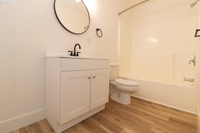 full bathroom featuring wood-type flooring, vanity, and washtub / shower combination