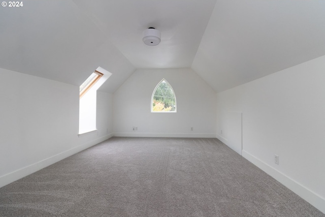 9 Waterford Downs, Florence, OR 97439 - additional living space featuring baseboards, light colored carpet, and vaulted ceiling