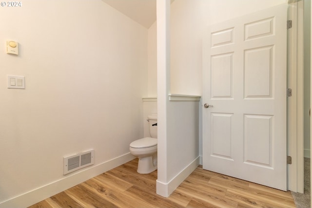 9 Waterford Downs, Florence, OR 97439 - bathroom with visible vents, baseboards, toilet, and wood finished floors