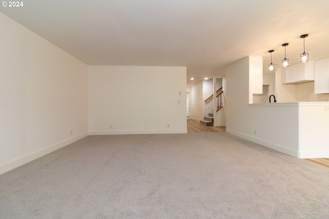9 Waterford Downs, Florence, OR 97439 - unfurnished living room with recessed lighting, stairs, light colored carpet, and baseboards