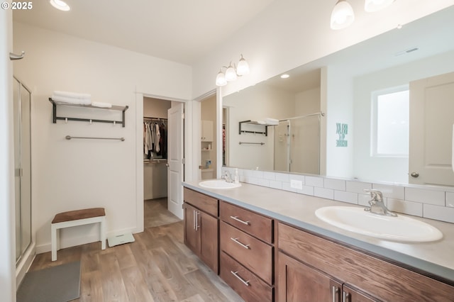 bathroom featuring wood-type flooring, vanity, and walk in shower