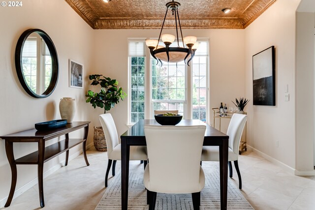 kitchen featuring custom range hood, decorative light fixtures, decorative backsplash, light stone countertops, and built in appliances