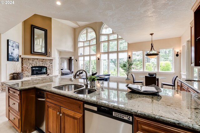 kitchen featuring backsplash, dishwasher, and light stone countertops