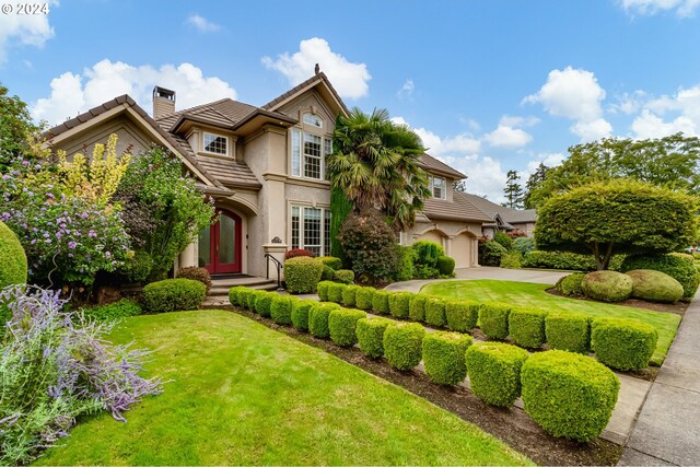 view of front of house with a garage and a front yard