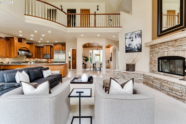 tiled living room with a healthy amount of sunlight and a high ceiling