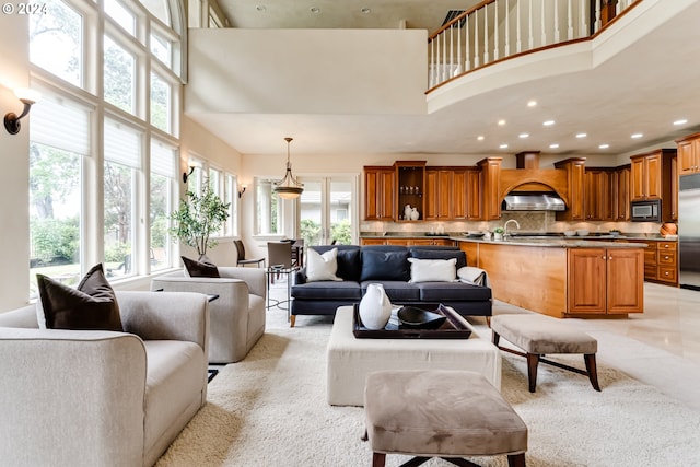 living room featuring decorative columns and a towering ceiling