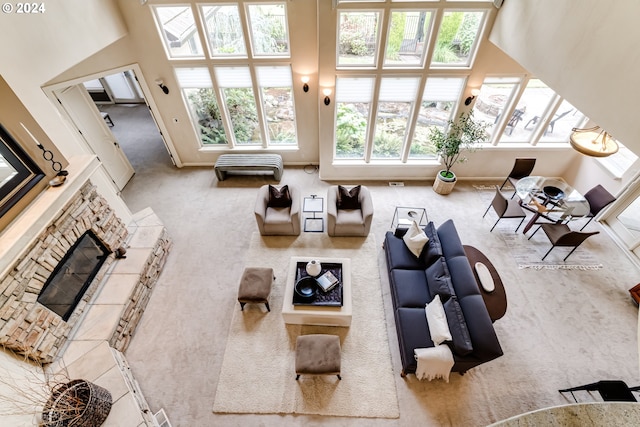 living area featuring a fireplace and carpet flooring