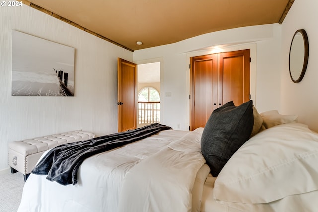 unfurnished bedroom with vaulted ceiling, a closet, and carpet flooring