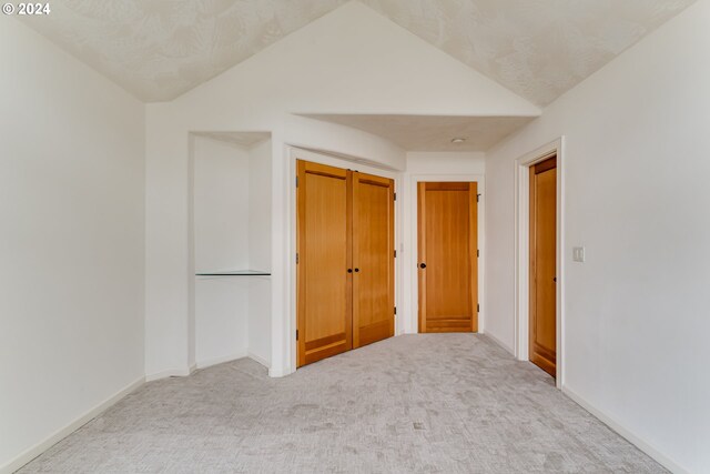 sitting room featuring ceiling fan, carpet, beamed ceiling, and a tile fireplace